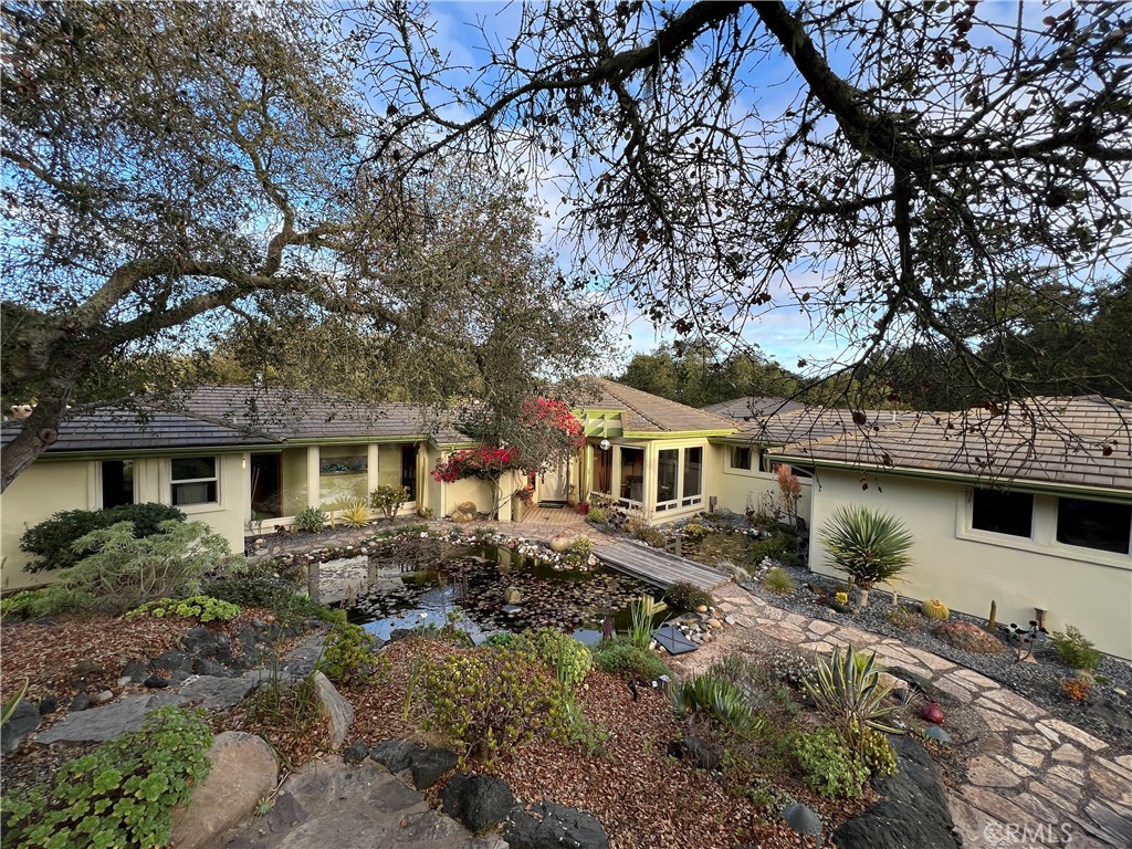 a front view of a house with a garden