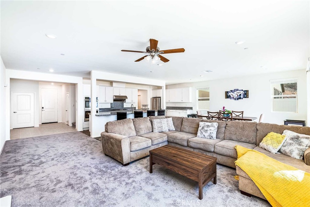 a living room with furniture and kitchen view