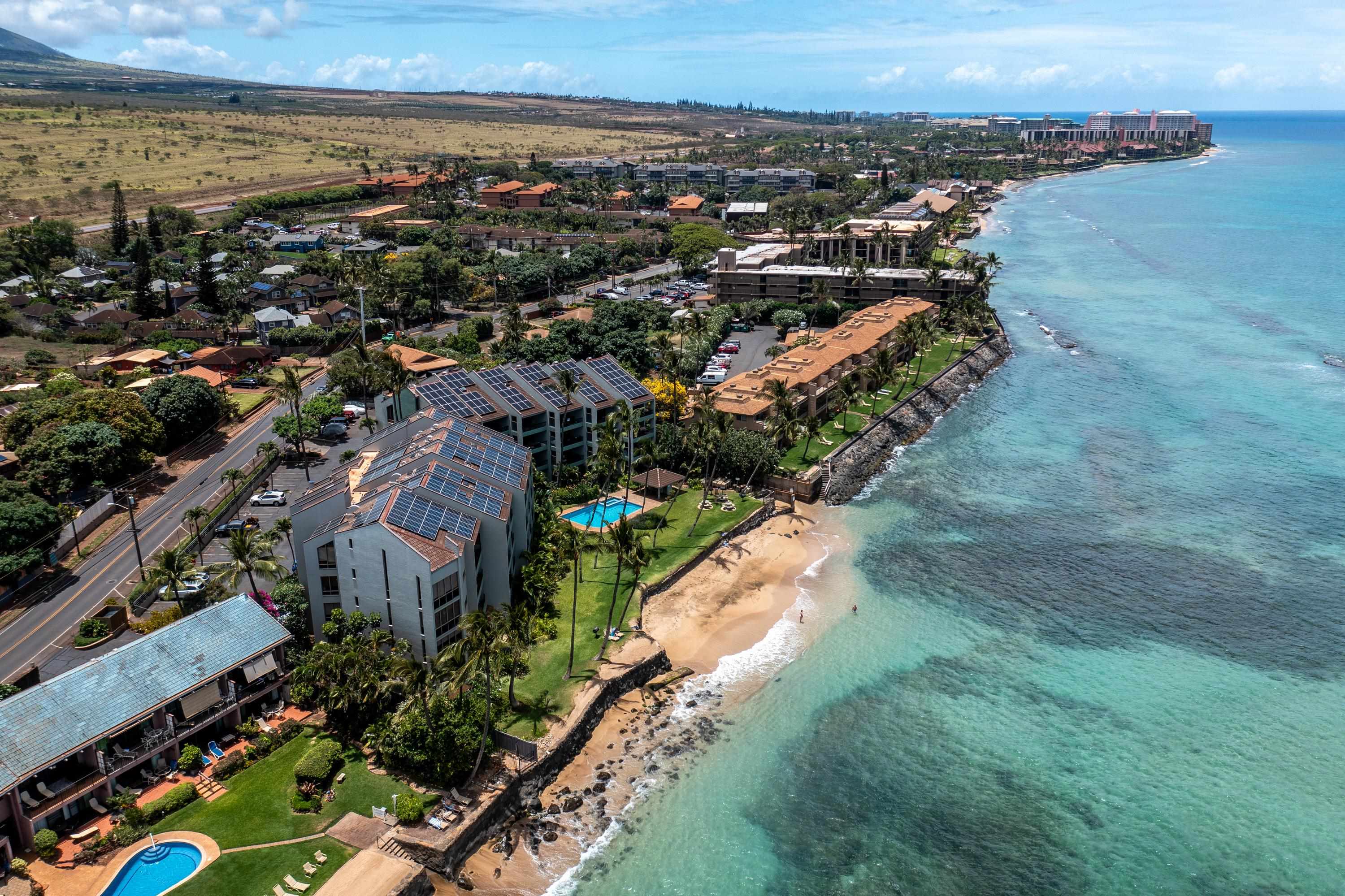 an aerial view of residential building and ocean