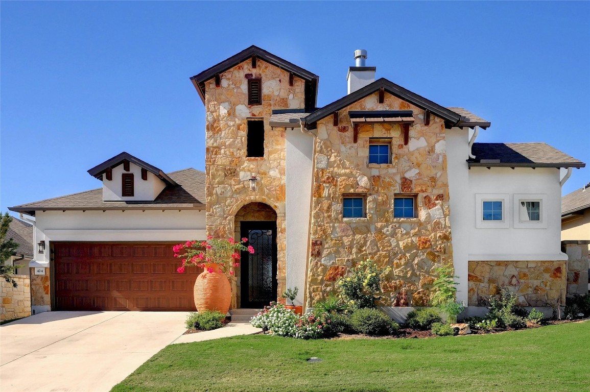 a front view of a house with a yard and garage