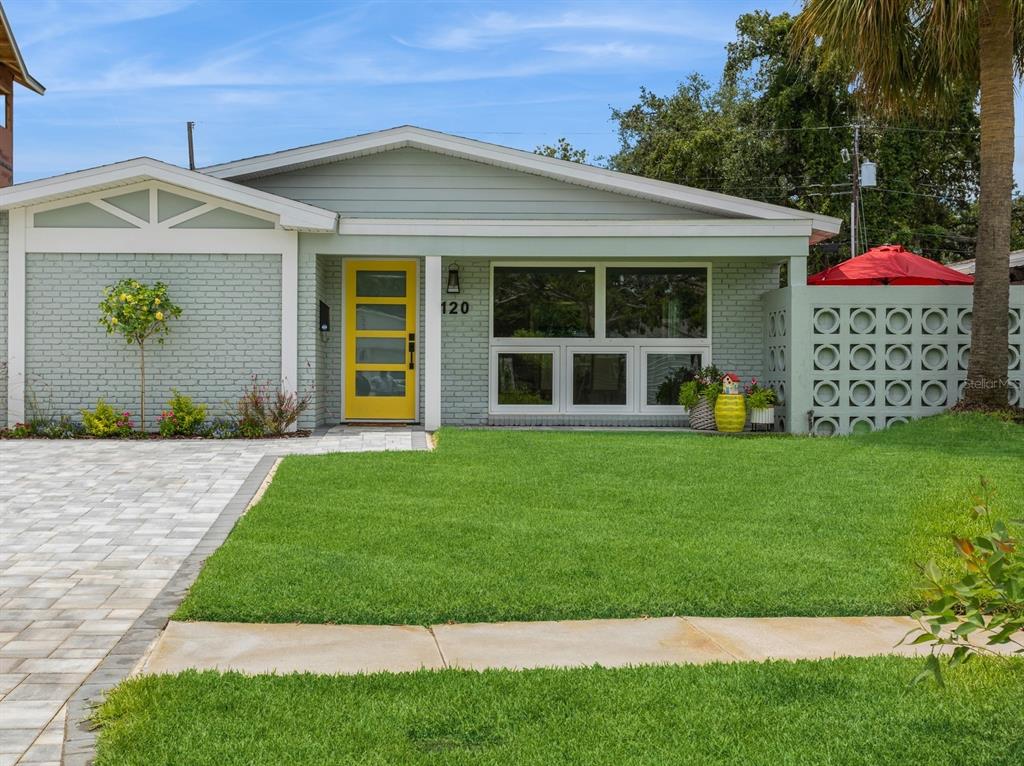 a front view of a house with a garden