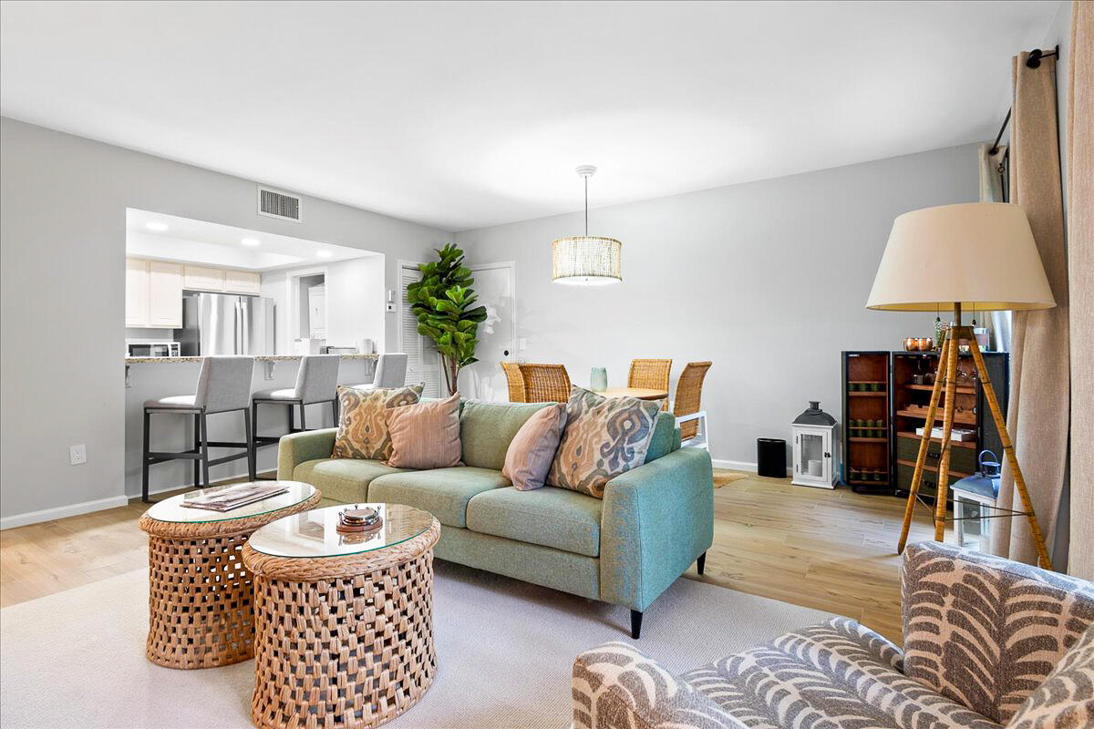 a living room with furniture a lamp and a window