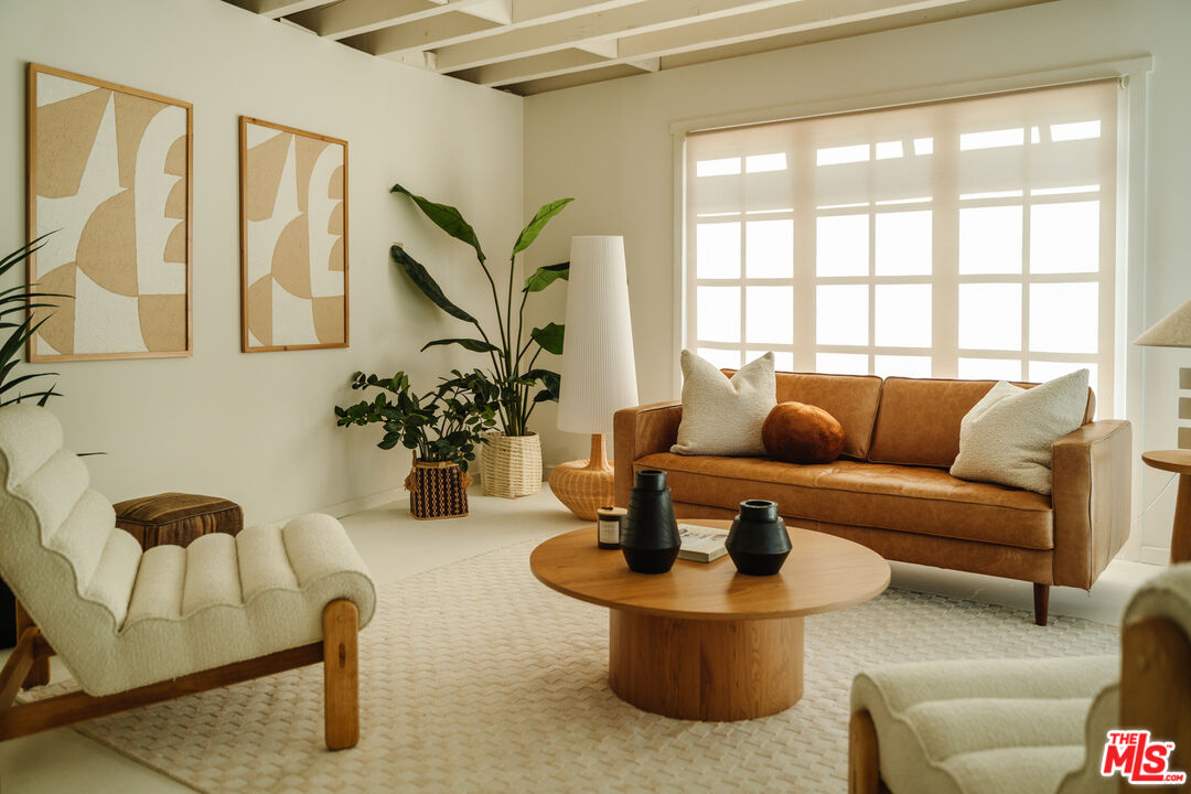 a living room with fireplace furniture and a potted plant