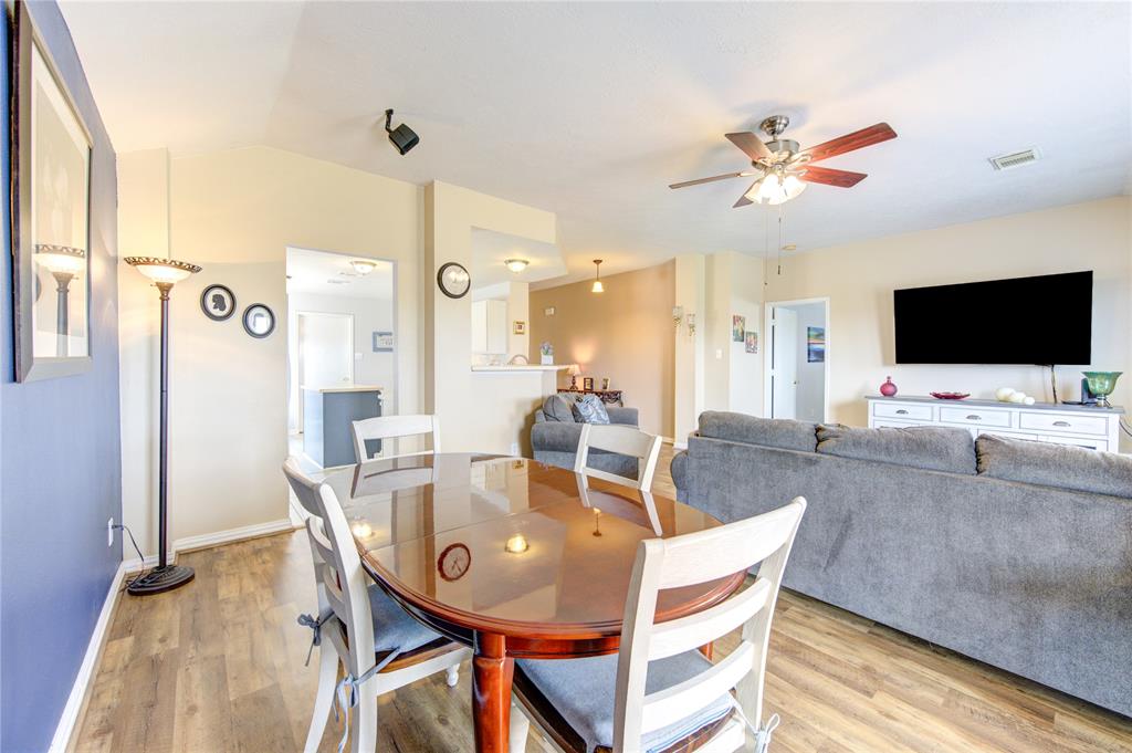 a dining room with furniture and wooden floor