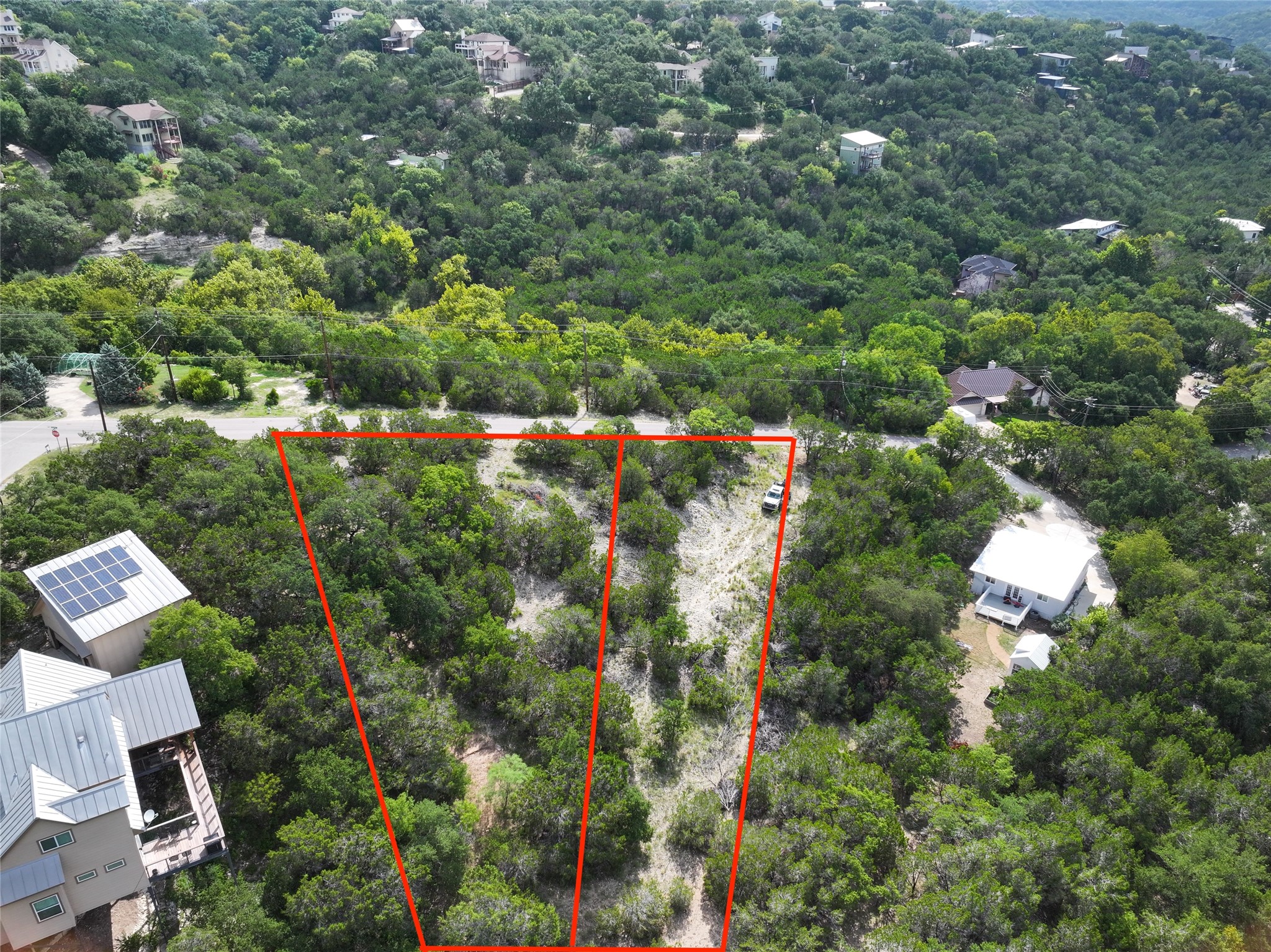 an aerial view of residential house with outdoor space and trees all around