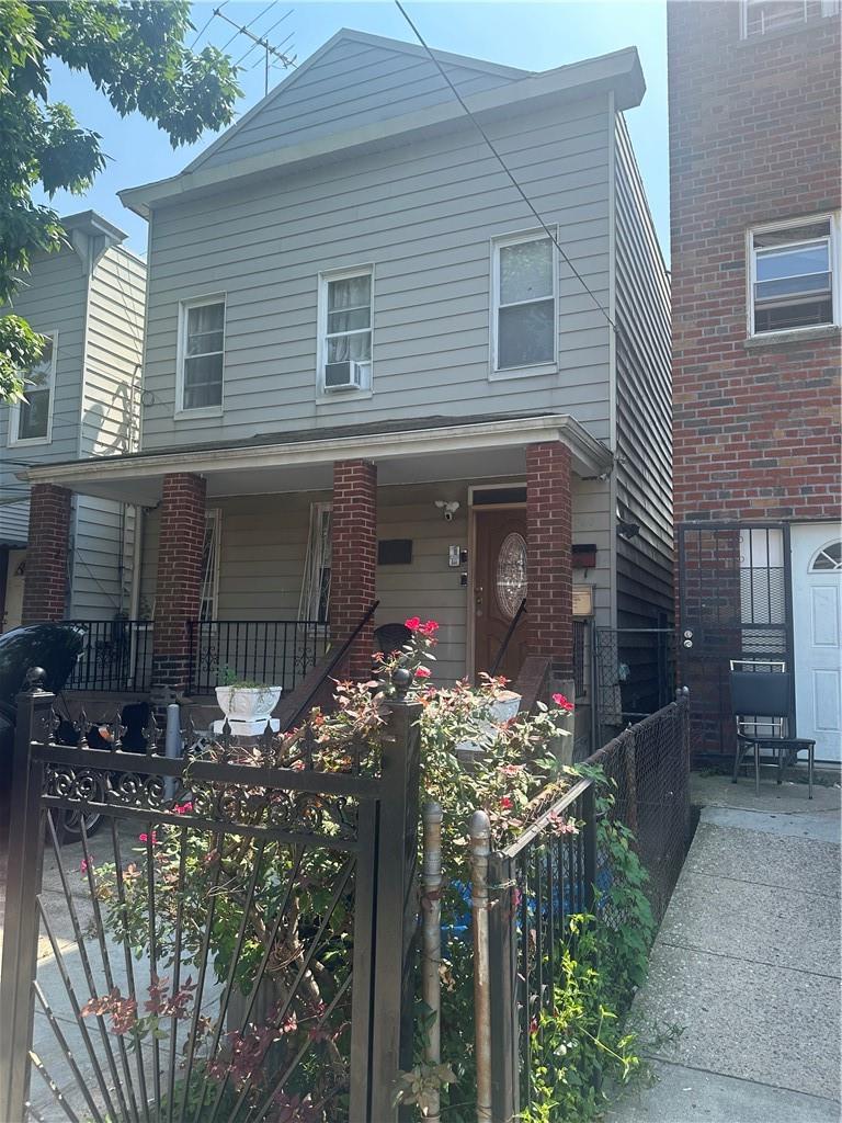 View of front of home with cooling unit and covered porch