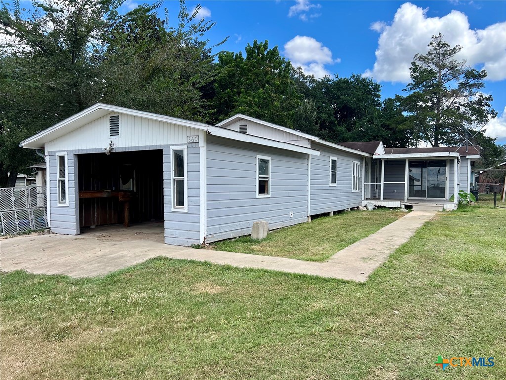 a view of a house with a yard and garage