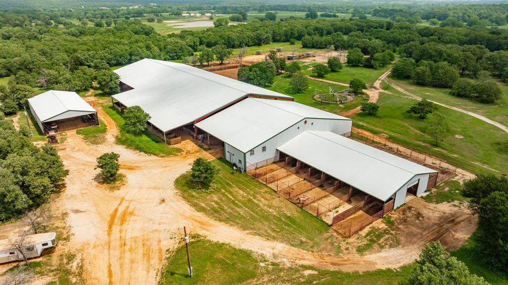 an aerial view of a house with a yard and lake view