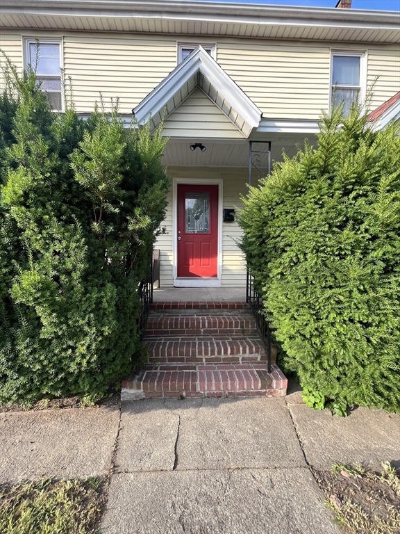 a front view of a house with lots of green space