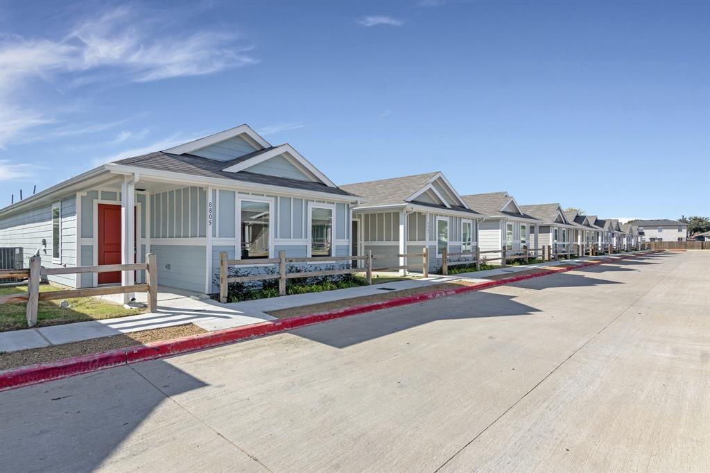 a view of house with outdoor space and view of residential house