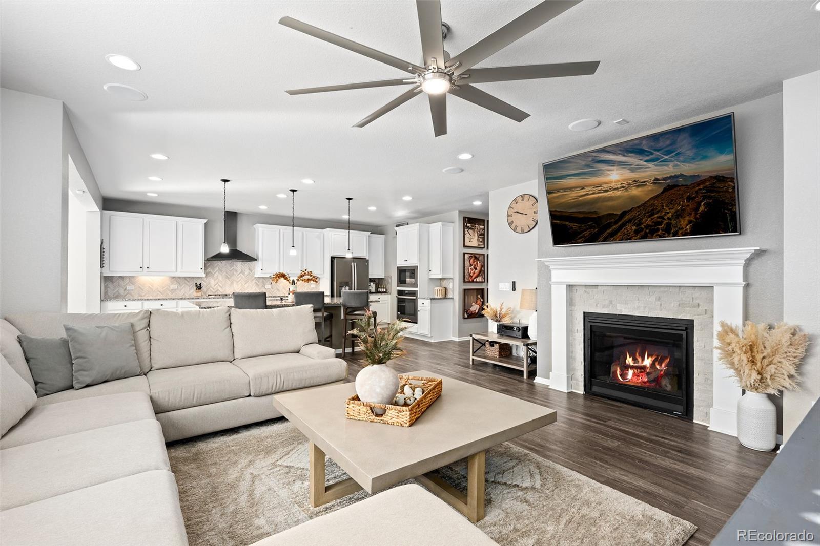 a living room with furniture a flat screen tv and a fireplace