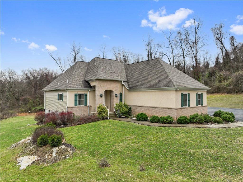 a front view of house with yard and green space