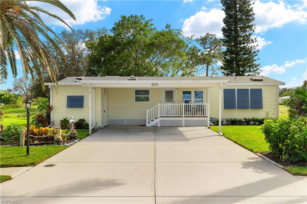 View of front of house featuring a front yard and a carport