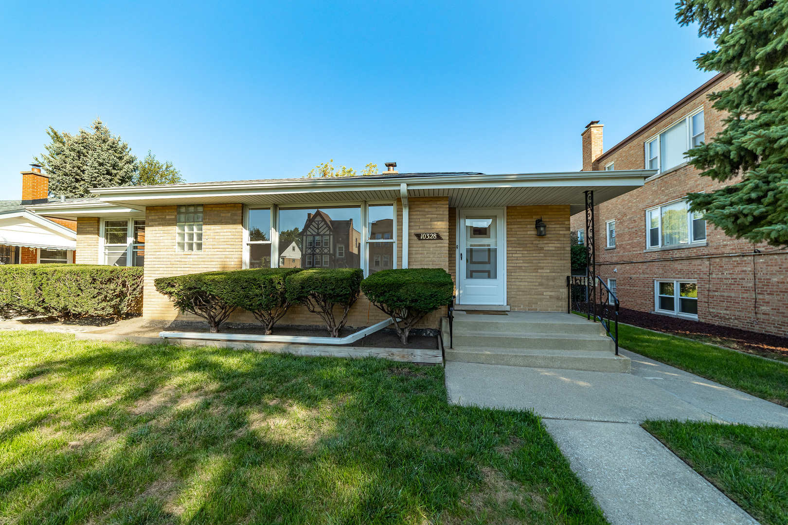 a front view of house with yard and green space