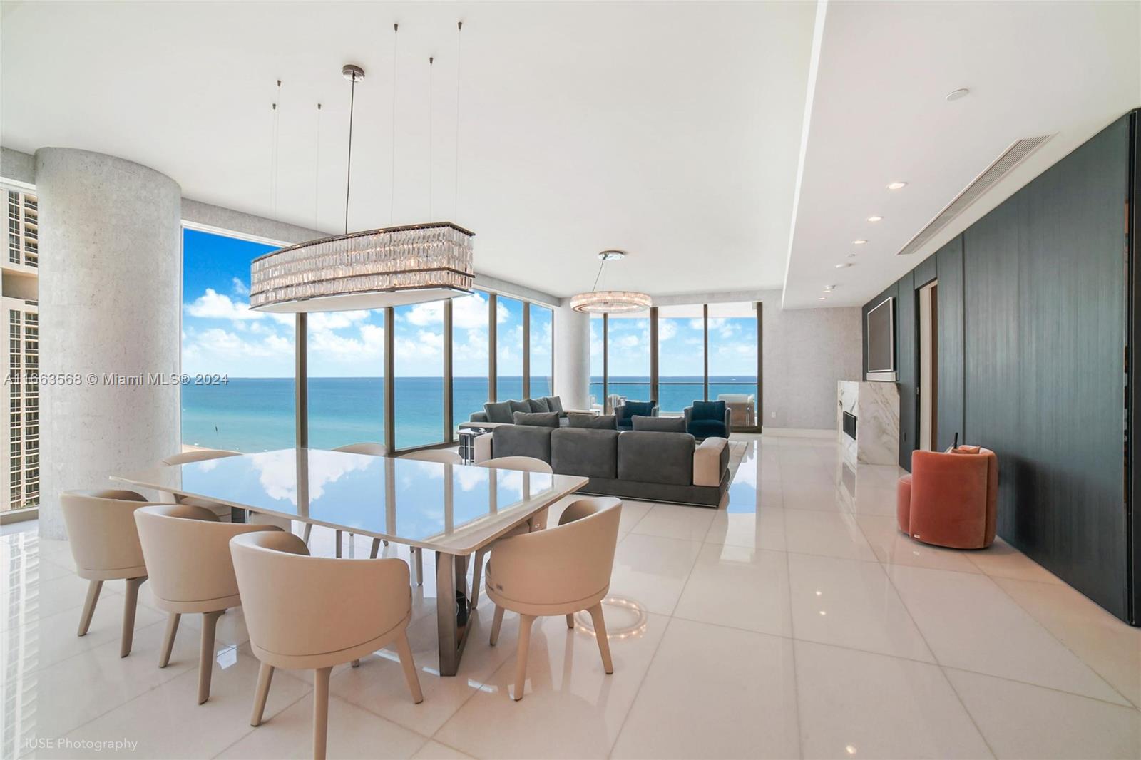 a view of a dining room with furniture a chandelier and wooden floor