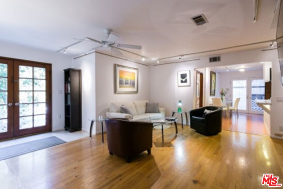 a living room with fireplace furniture and a wooden floor