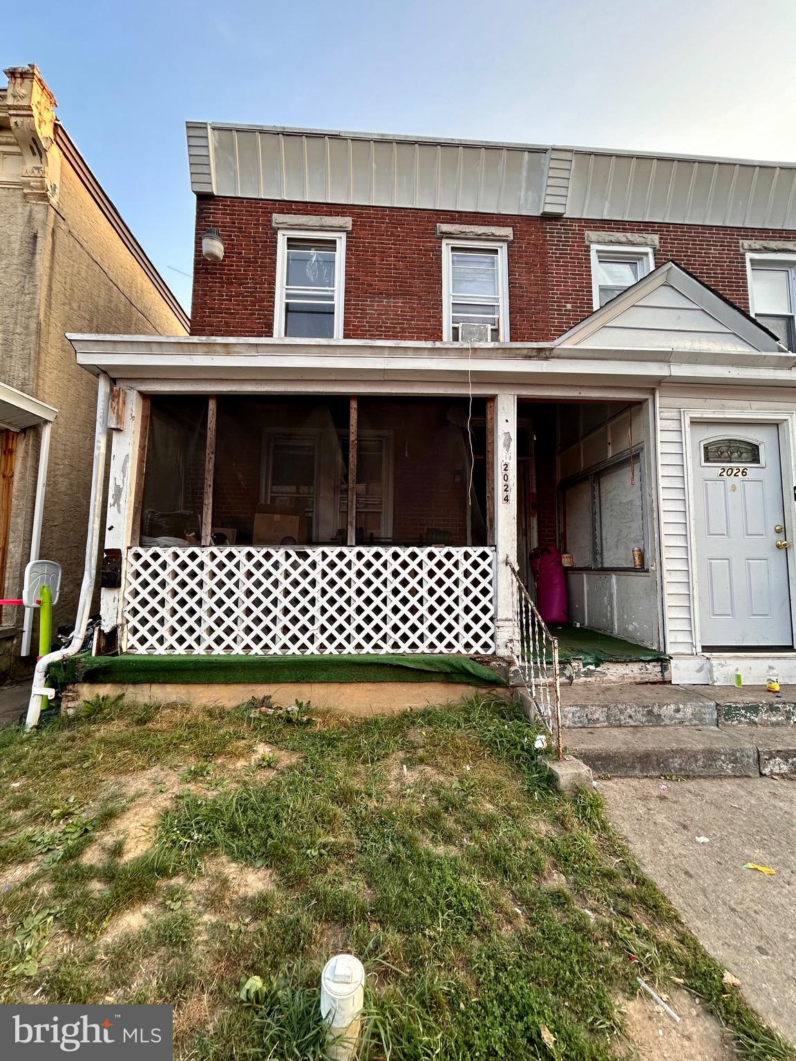 a view of a brick house with wooden fence