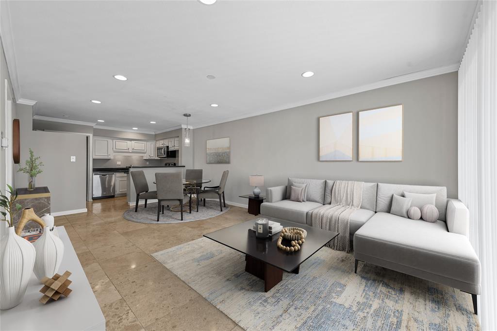 a living room with furniture and view of kitchen