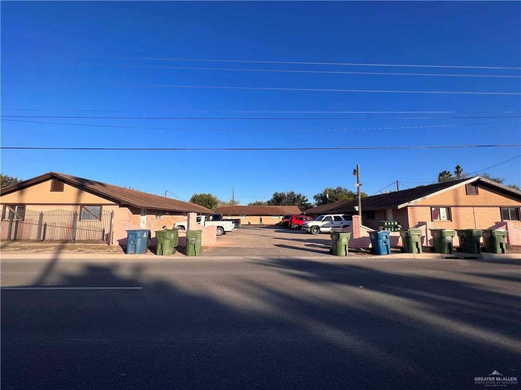 a view of street with a car parked on the road