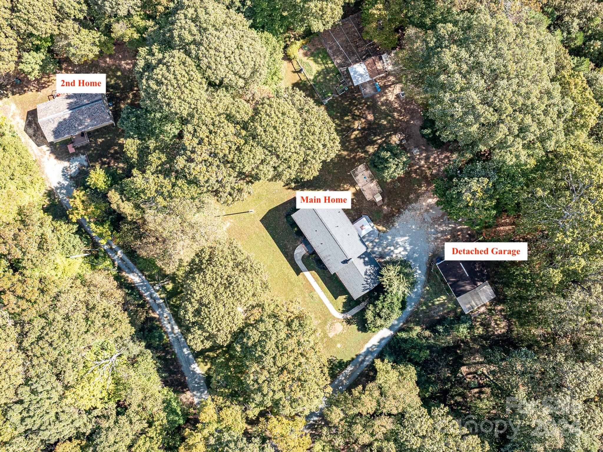 an aerial view of house with yard and mountain view in back