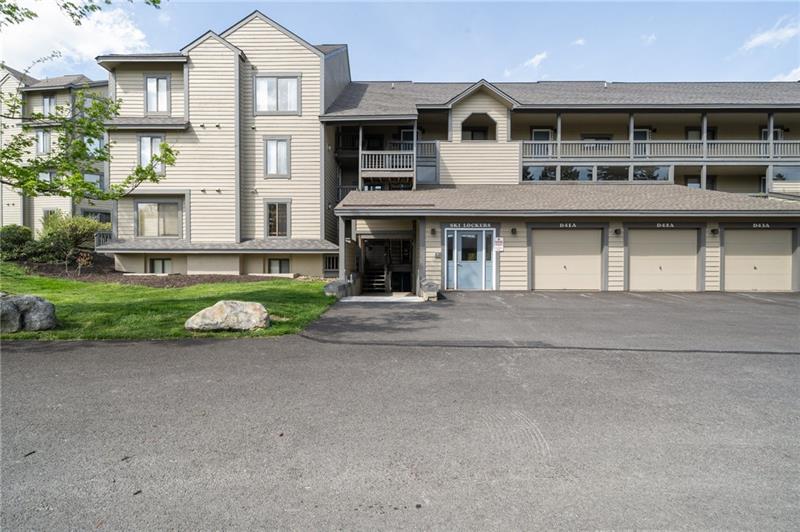 a view of a big house with many windows and a yard