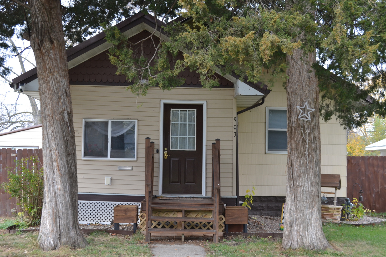 front view of a house with a tree