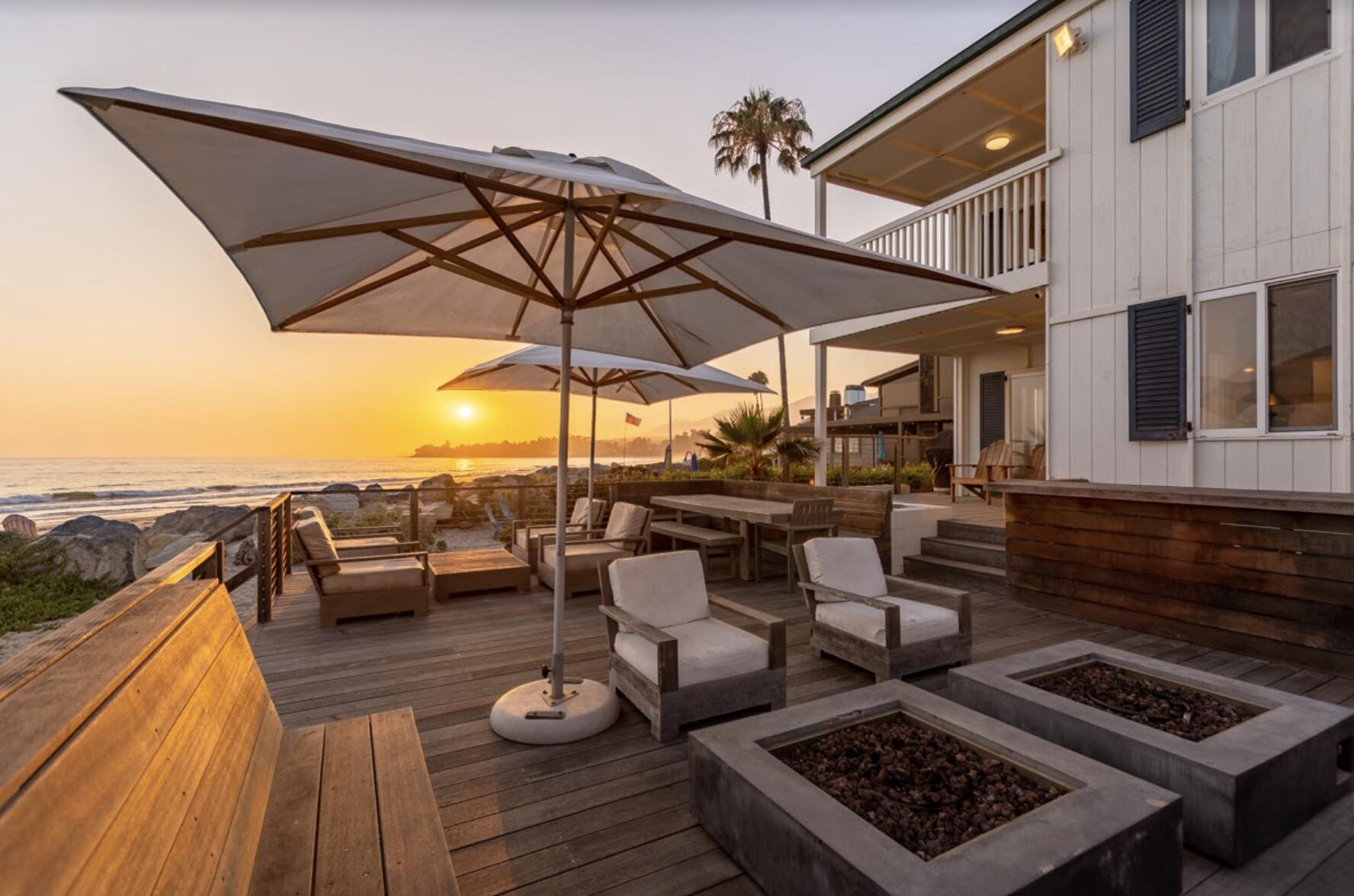 a view of a roof deck with couch and chairs