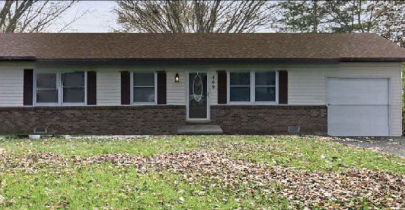 front view of a house with a yard