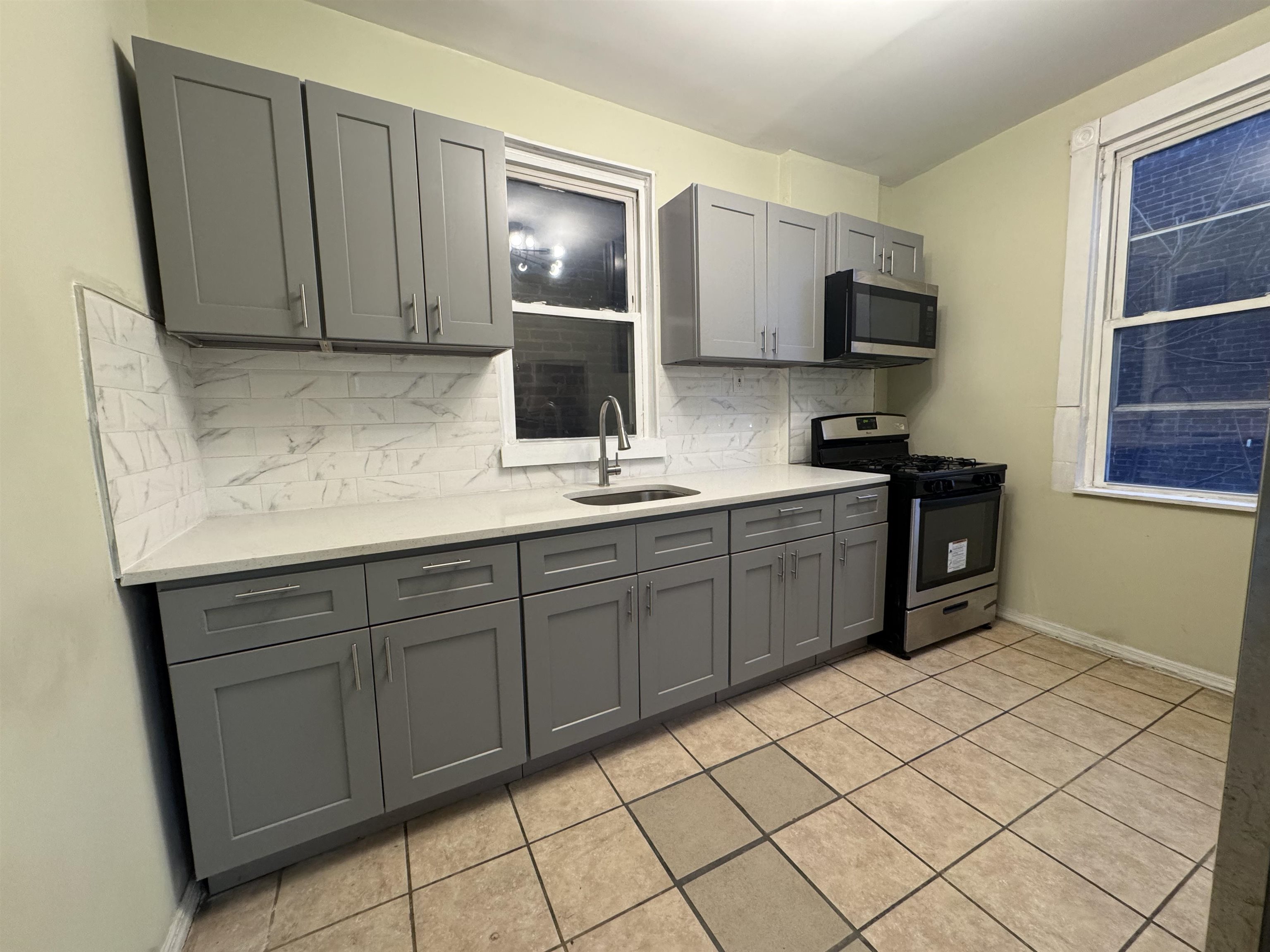 a kitchen with stainless steel appliances granite countertop a sink and a stove