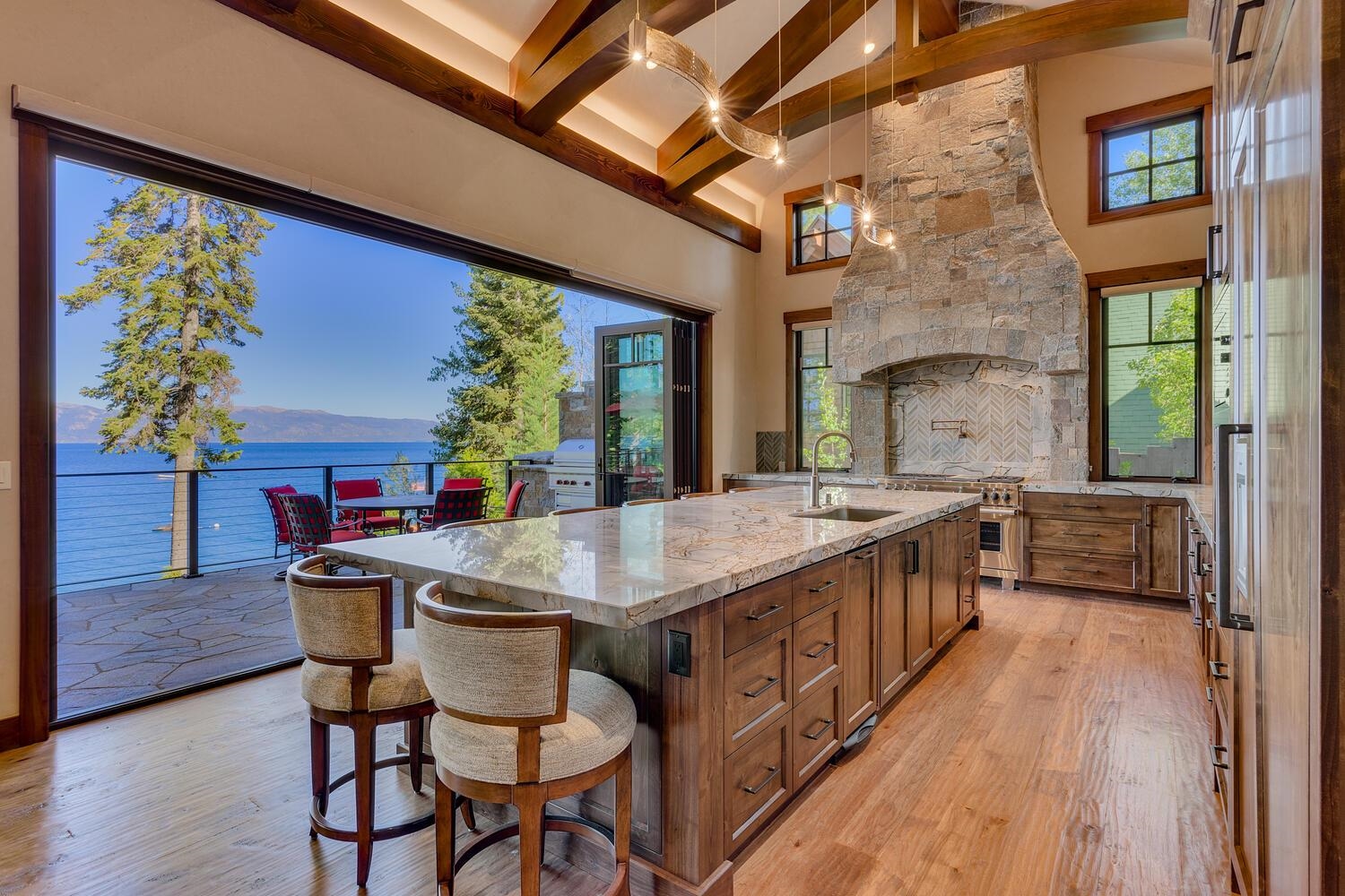 a kitchen with stainless steel appliances granite countertop a sink and wooden floors