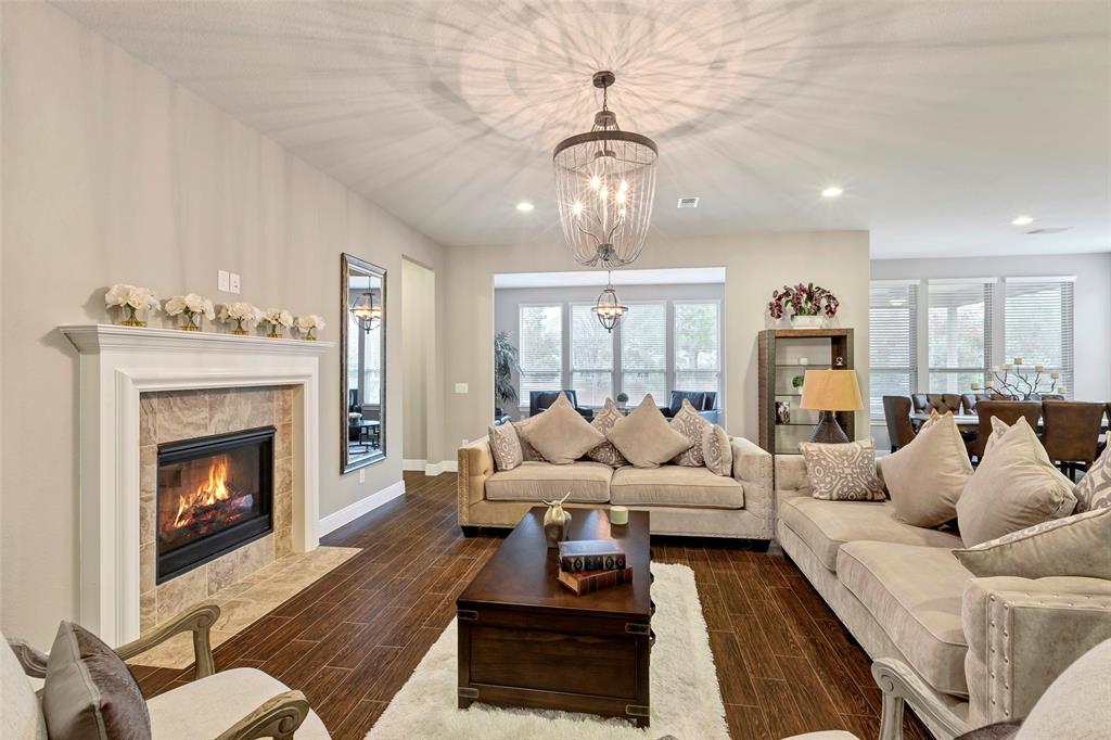 a living room with furniture fireplace and kitchen view