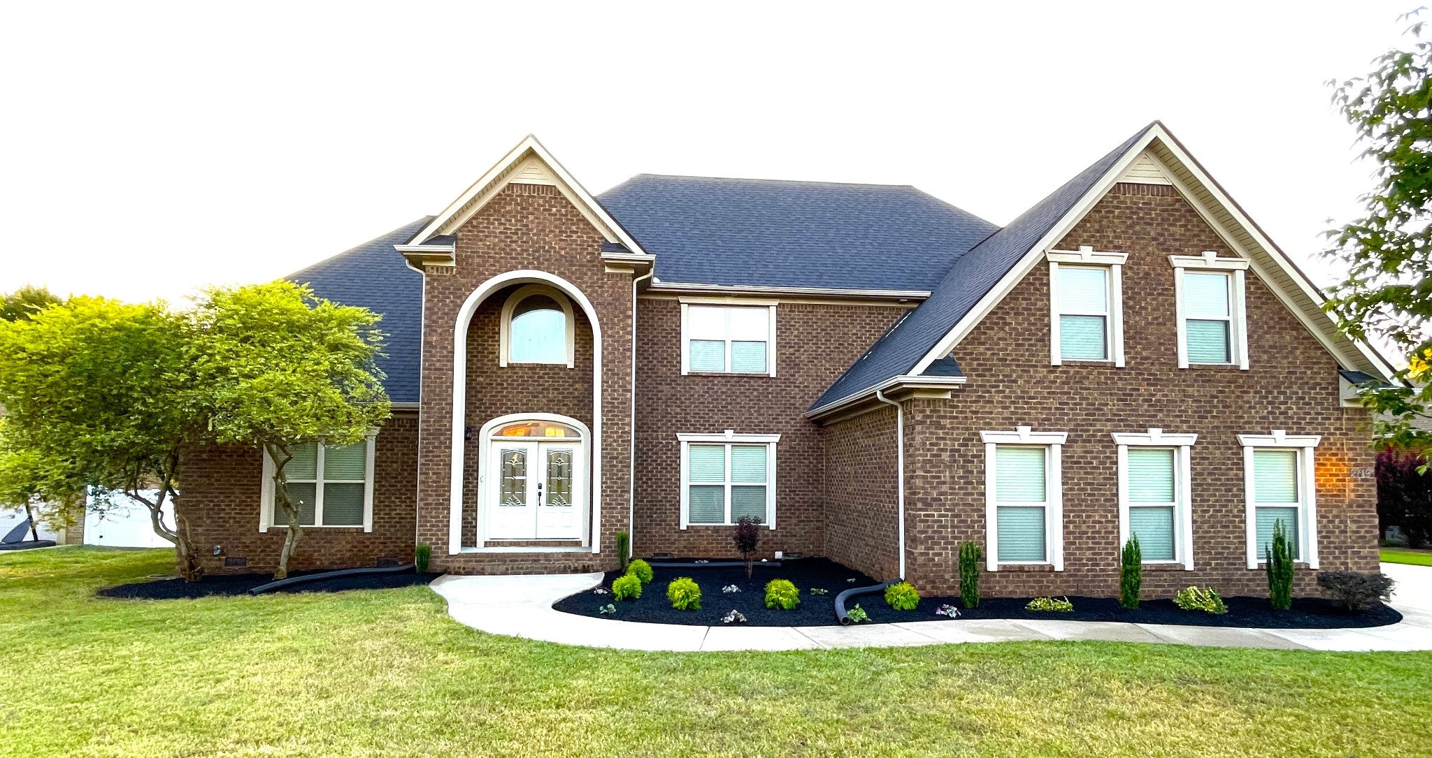 a front view of a house with a yard