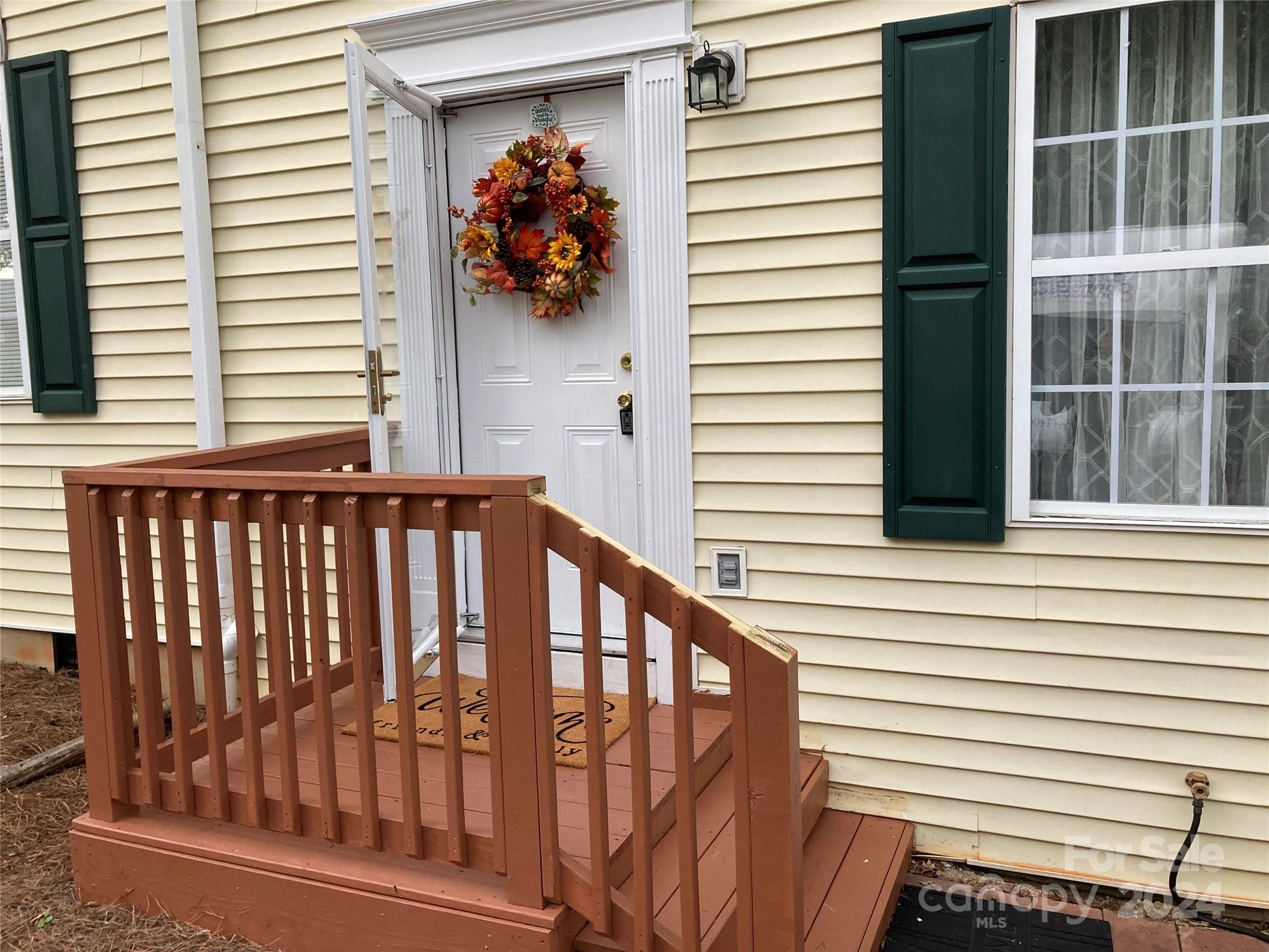 a view of a porch with a chair and a potted plant