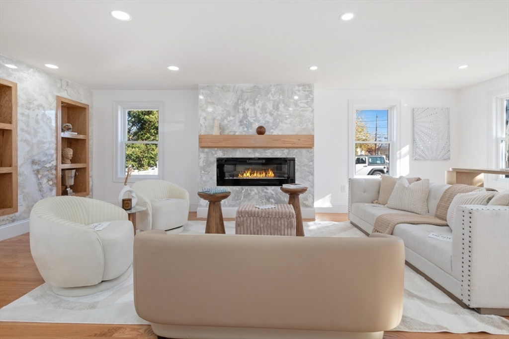 a living room with furniture and a fireplace