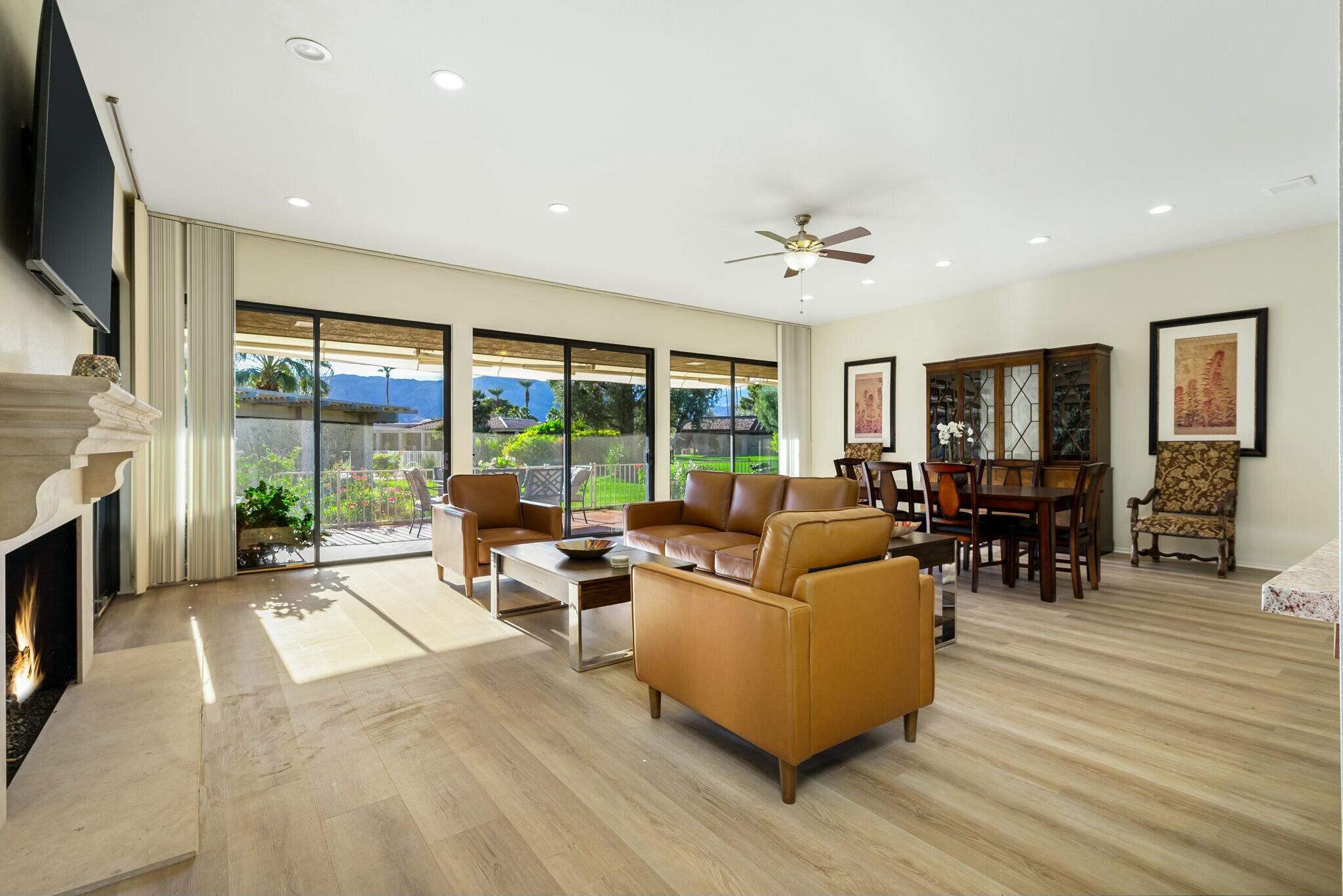 a living room with furniture fireplace and flat screen tv