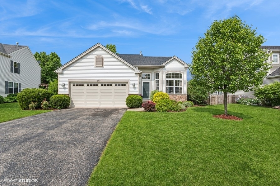 a front view of a house with a yard and garage