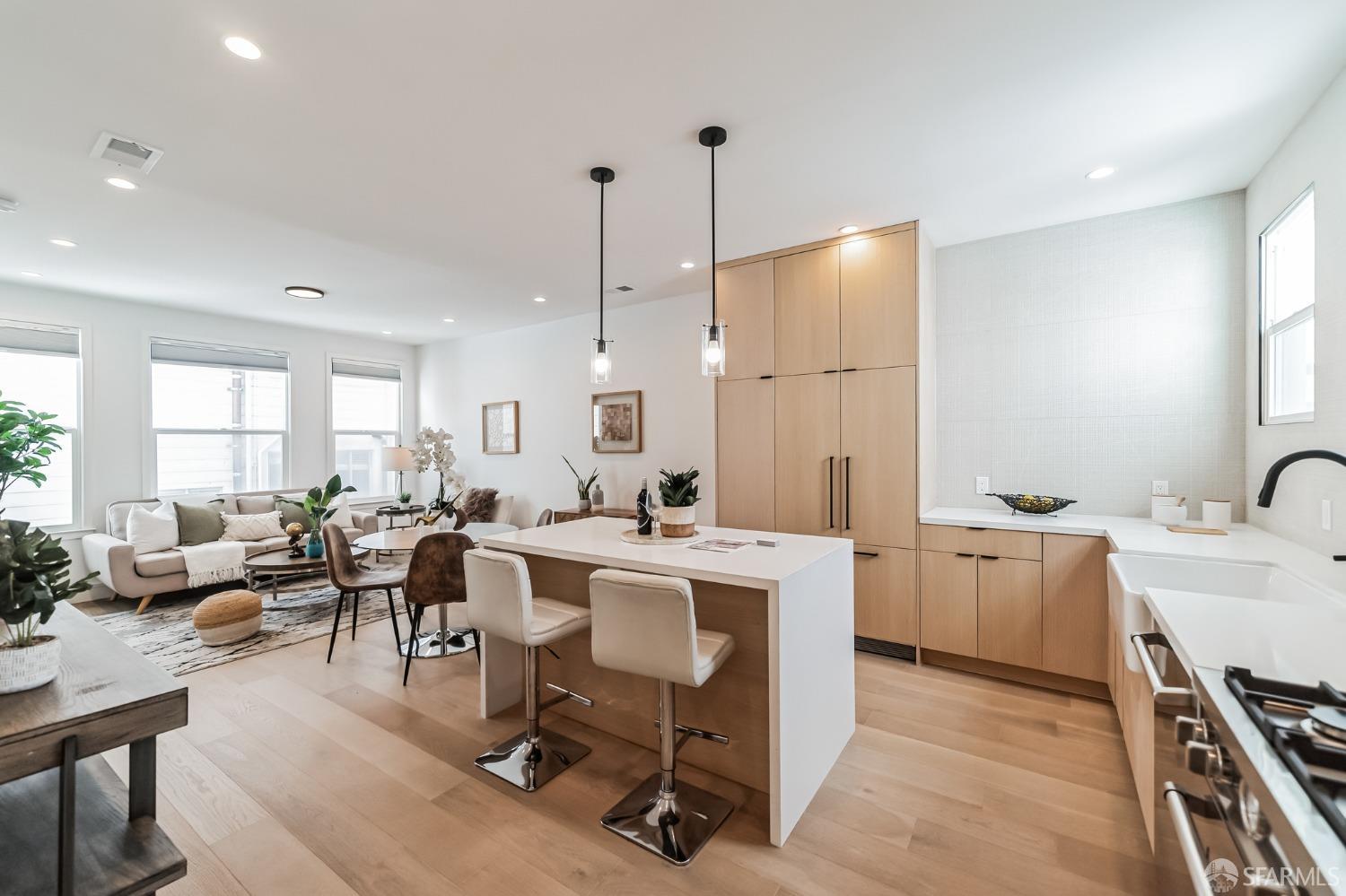 a large kitchen with a table and chairs