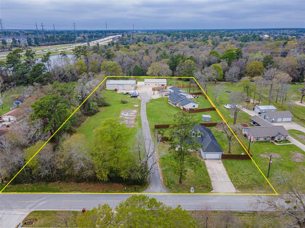 an aerial view of a residential houses with outdoor space and a lake view