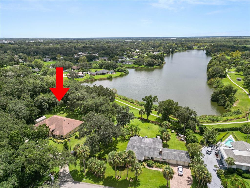 an aerial view of a houses with a lake view