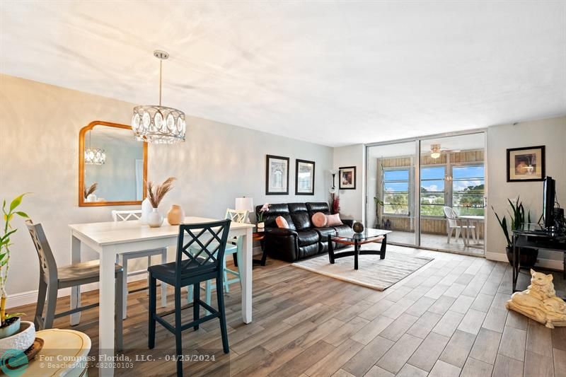 a living room with furniture a flat screen tv and a large window