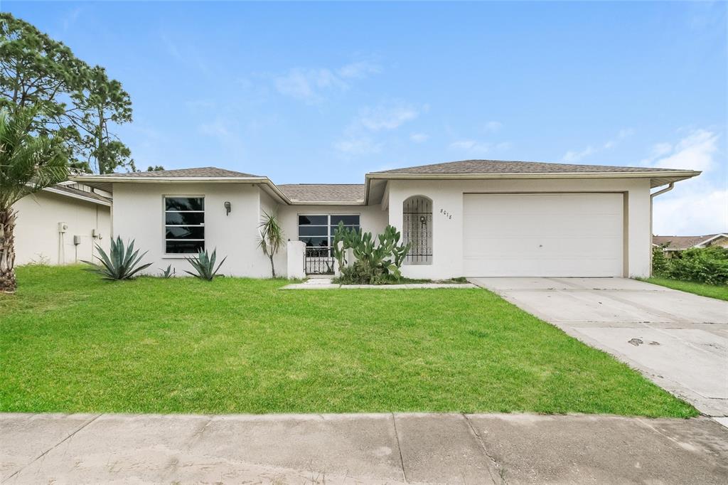 a front view of house with yard and green space