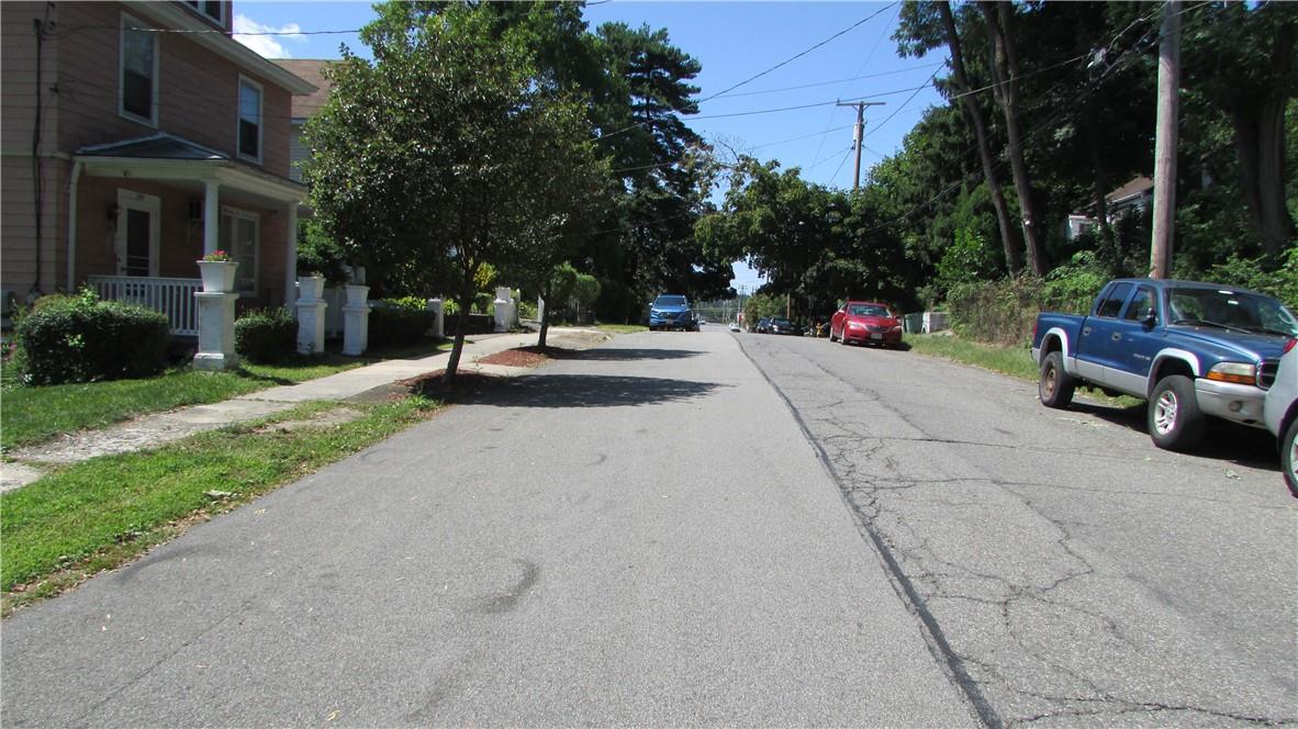 a view of a street with houses on both side of the road