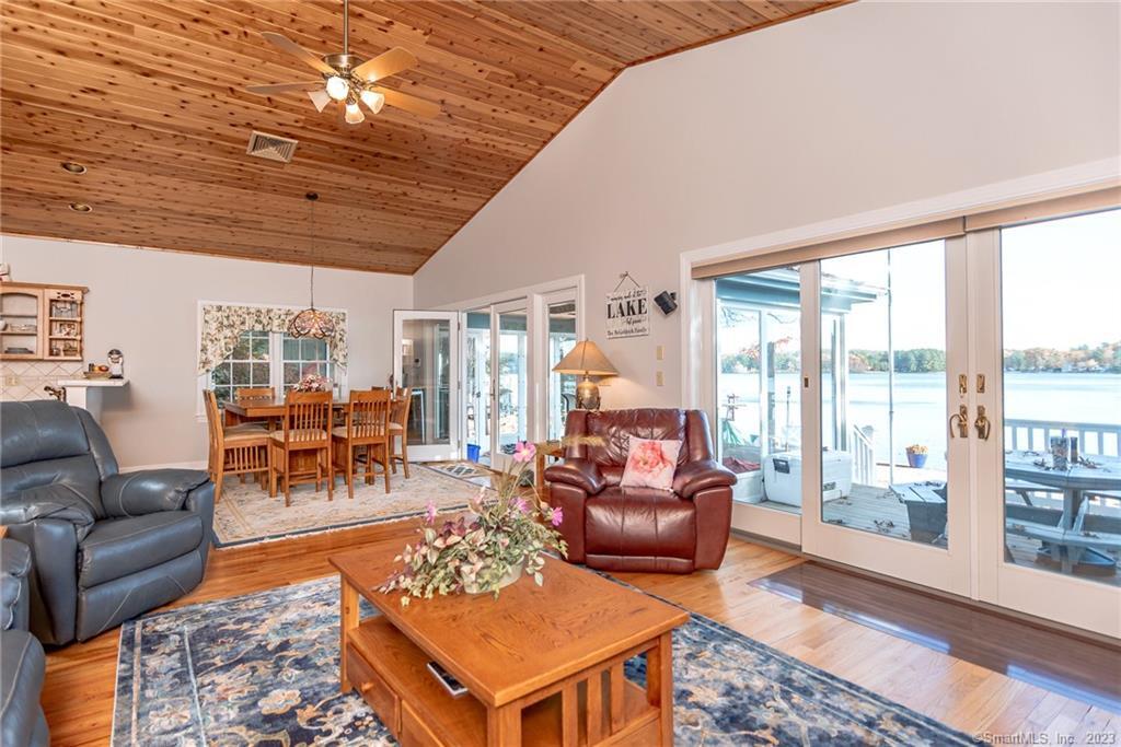 a living room with furniture a wooden floor and next to a window