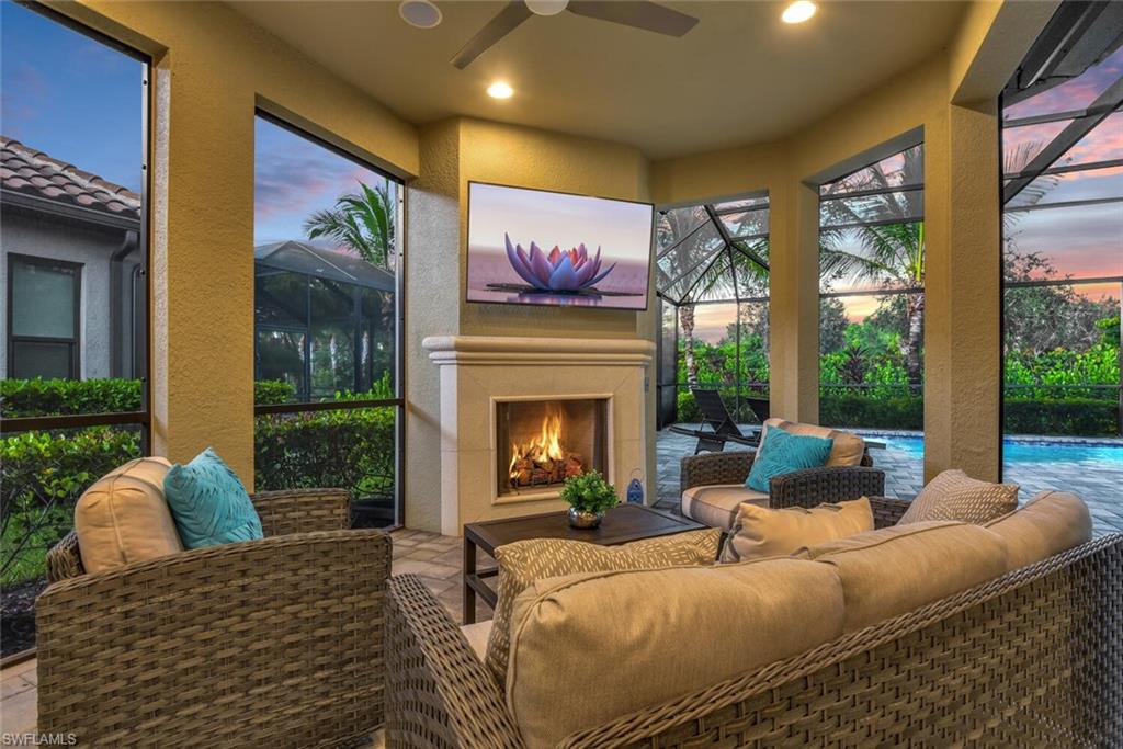 a living room with furniture a fireplace and a large window