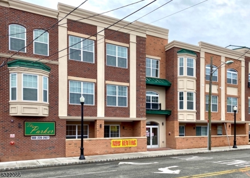 a front view of a residential apartment building with a yard