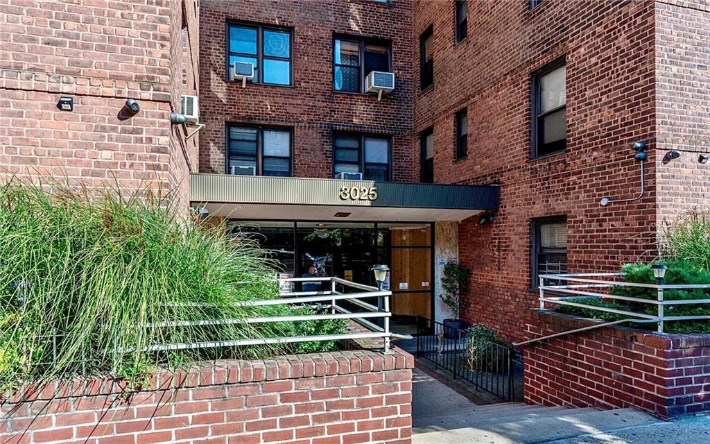 a front view of a building with plants