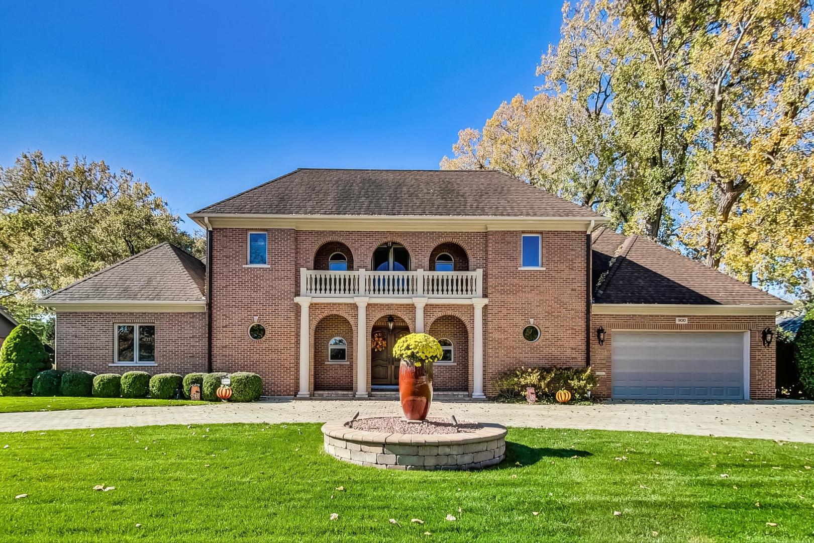 a front view of a house with a garden and yard