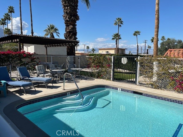 a view of a swimming pool with chairs