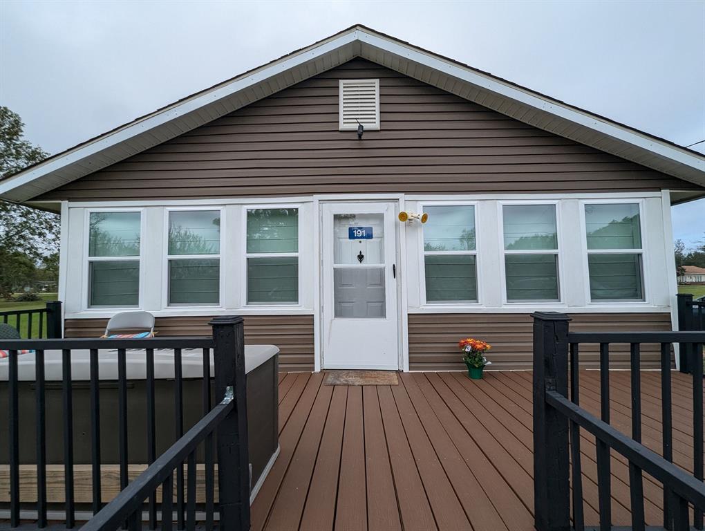 a view of a house with a wooden deck