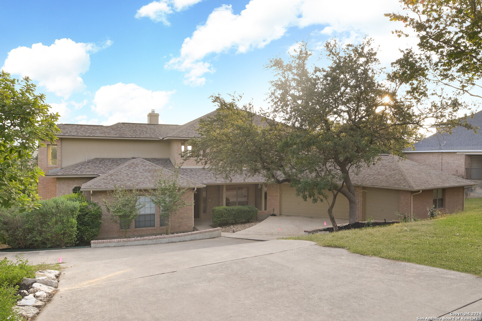 a front view of a house with a yard and garage